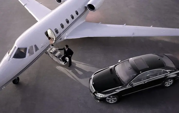 aerial view white private jet airplane man standing at gate black Mercedes Benz E Class Charter service at airport transfer